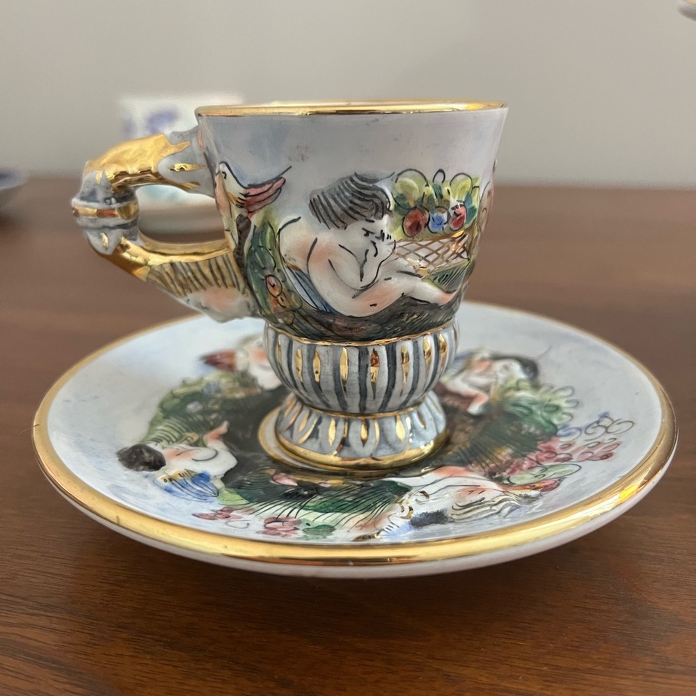 Capodimonte demitasse cup and saucer cherubs